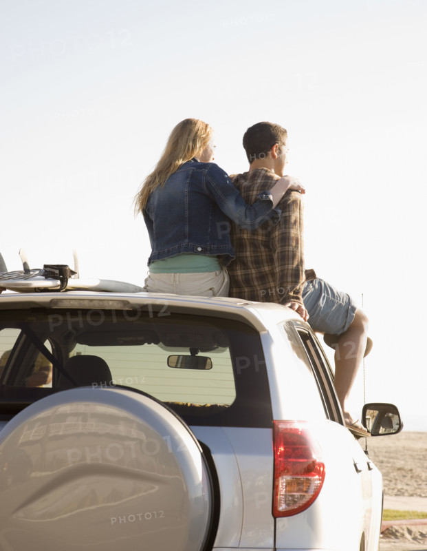 Couple sitting on top of car. Date : 2008
