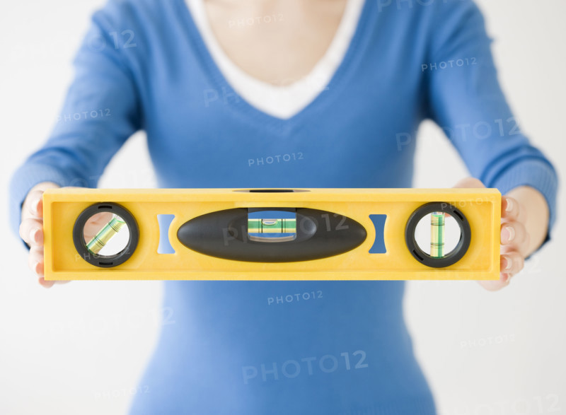Woman holding level tool. Date : 2008