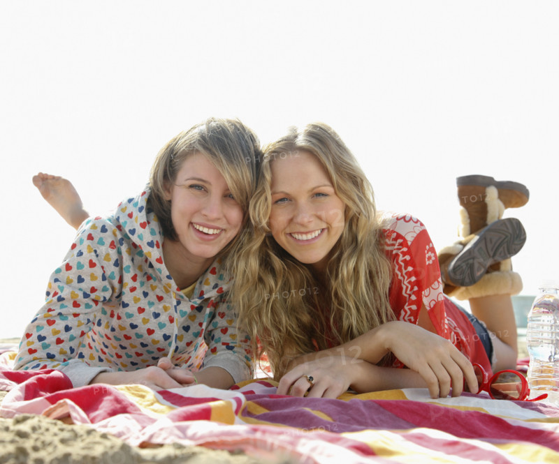 Two young women laying on beach. Date : 2008