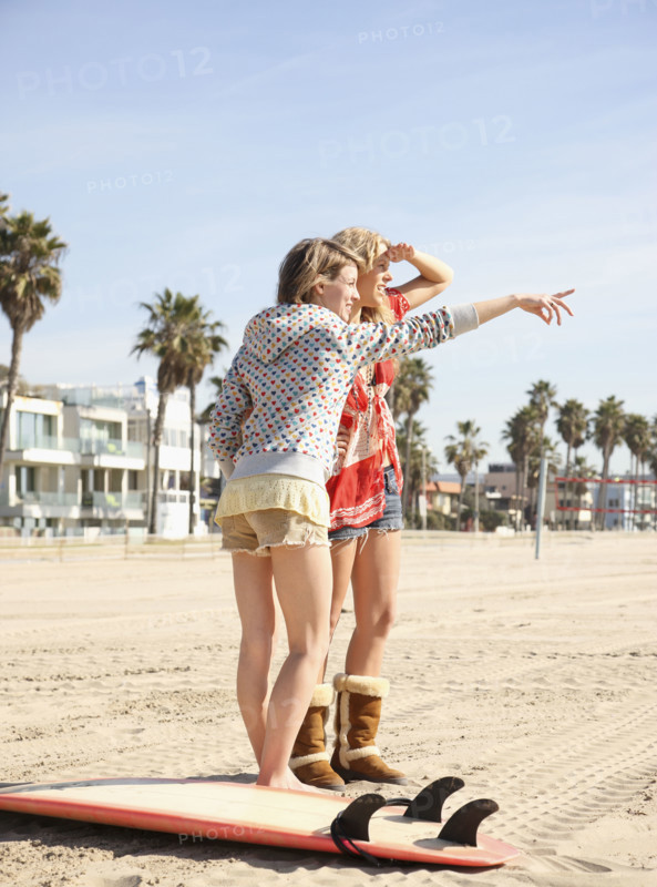 Two young women standing on beach. Date : 2008