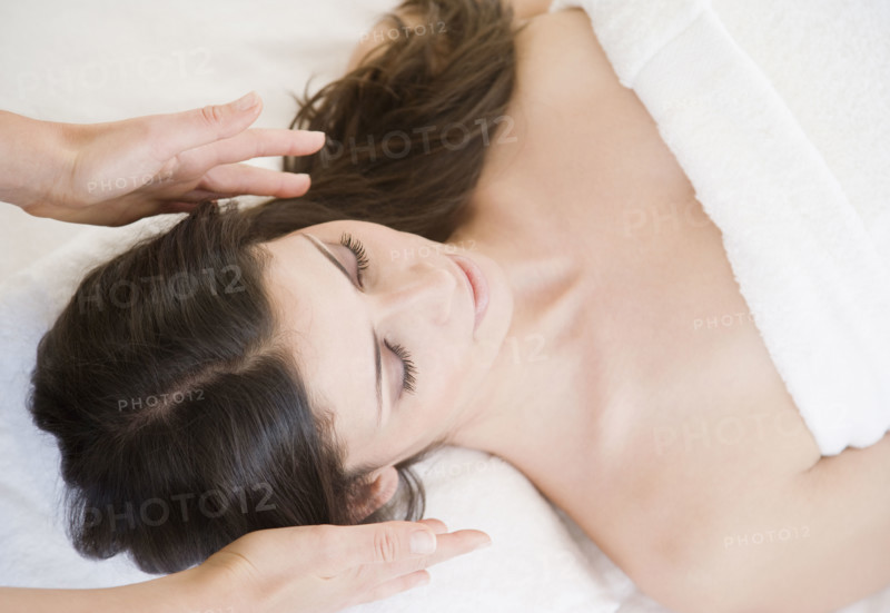 Woman receiving energy therapy. Date : 2008