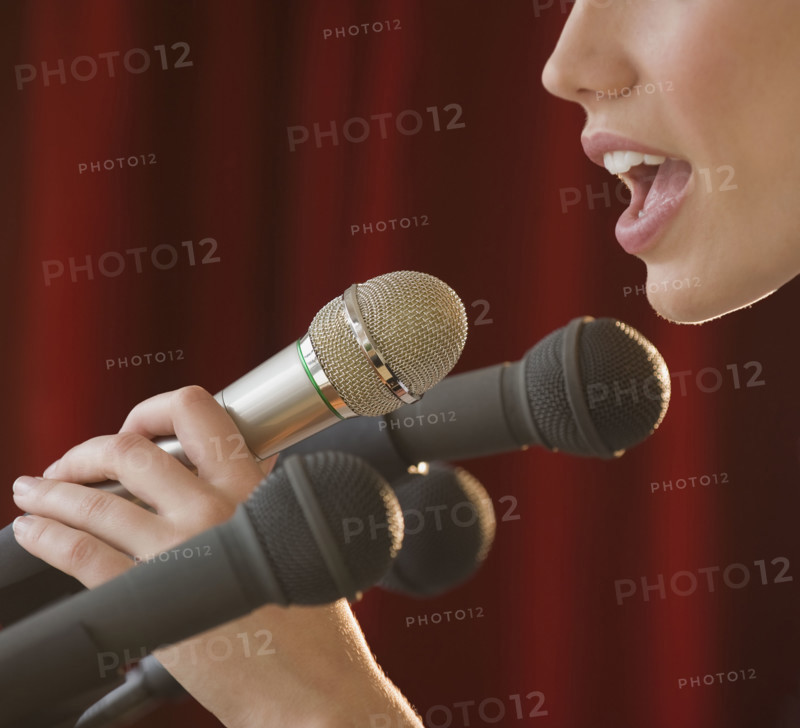 Woman speaking into microphone.