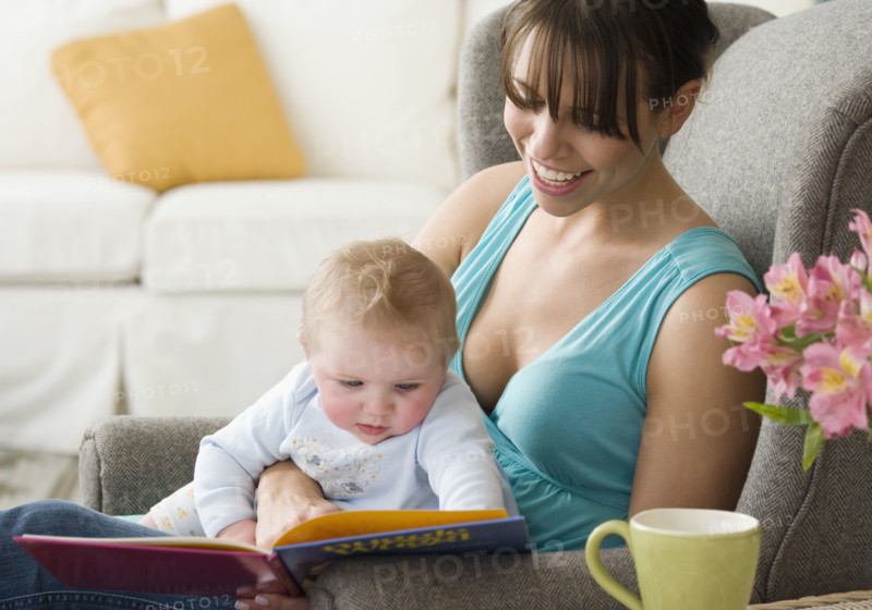 Mother and baby looking at book. Date : 2008