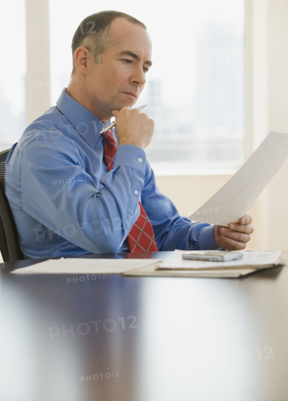 Businessman reading paperwork.