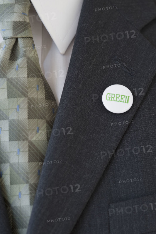 Eco-friendly button on businessman’s lapel.