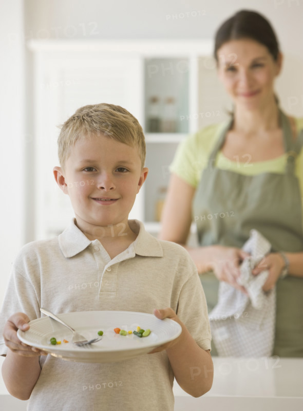 Boy holding dinner plate.