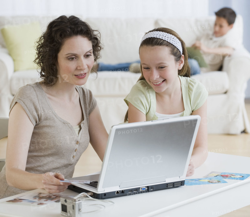 Mother and daughter looking at laptop.