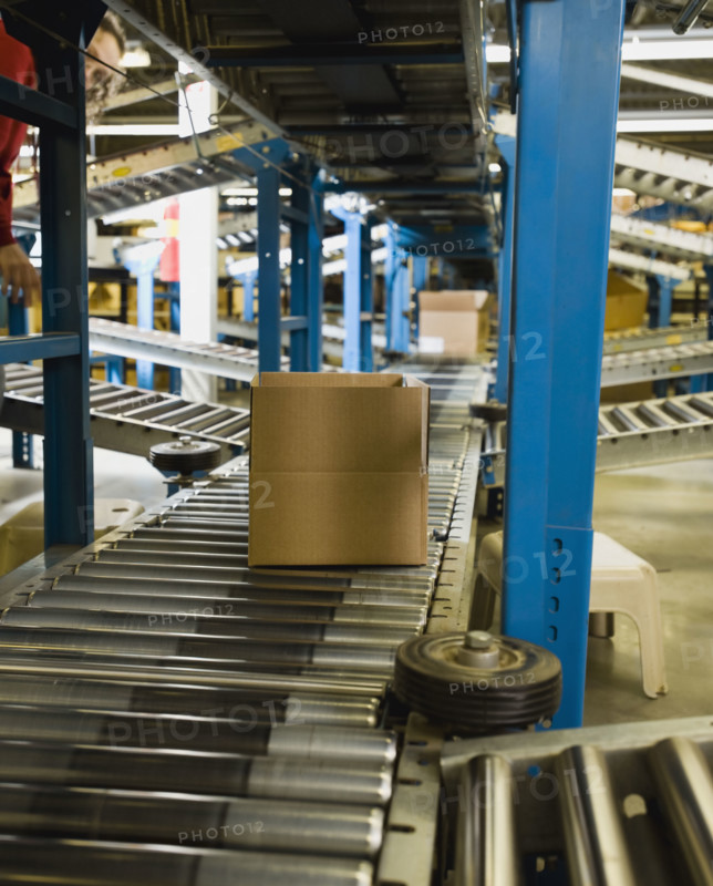 Boxes on conveyor belt in warehouse. Date : 2008