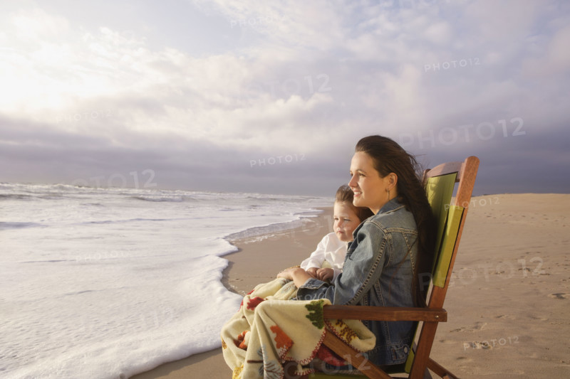Mother and child sitting in beach chair. Date : 2008