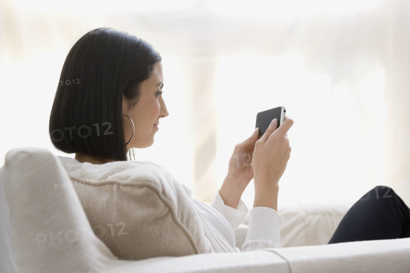 Woman looking at cell phone. Date : 2008
