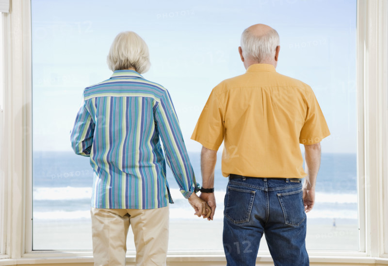 Senior couple looking out window. Date : 2008