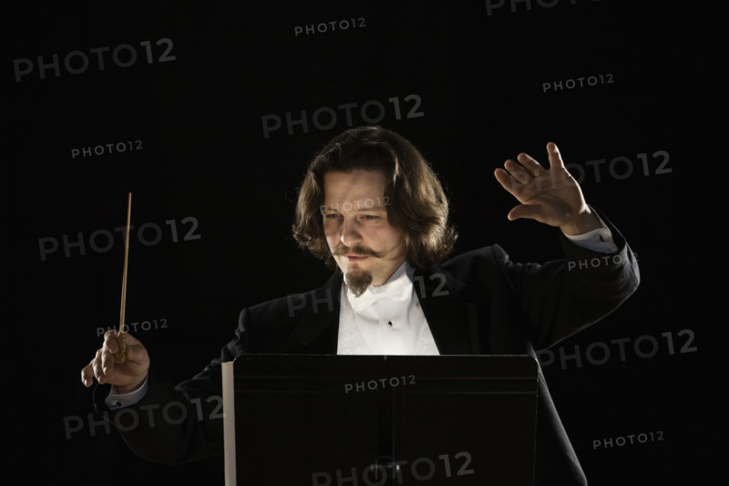 Man conducting behind music stand. Date : 2008