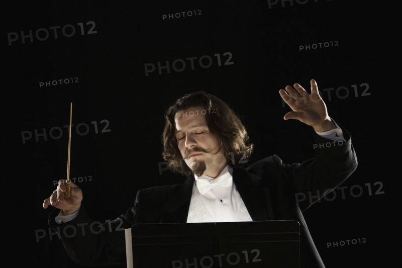 Man conducting behind music stand. Date : 2008