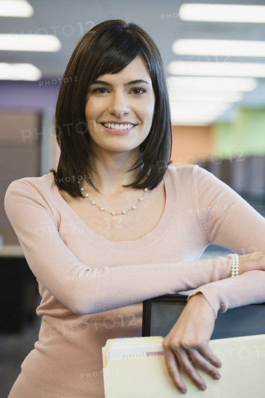 Businesswoman leaning on cubicle wall. Date : 2008