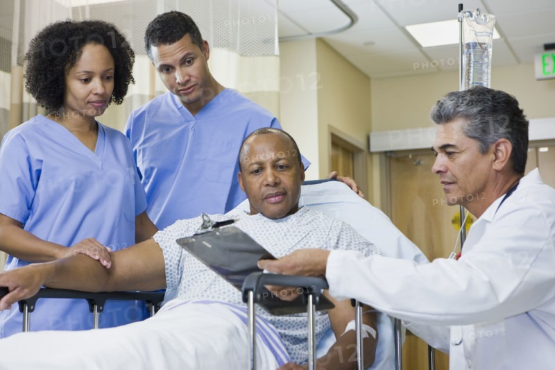 African man in hospital gurney looking at clipboard. Date : 2008