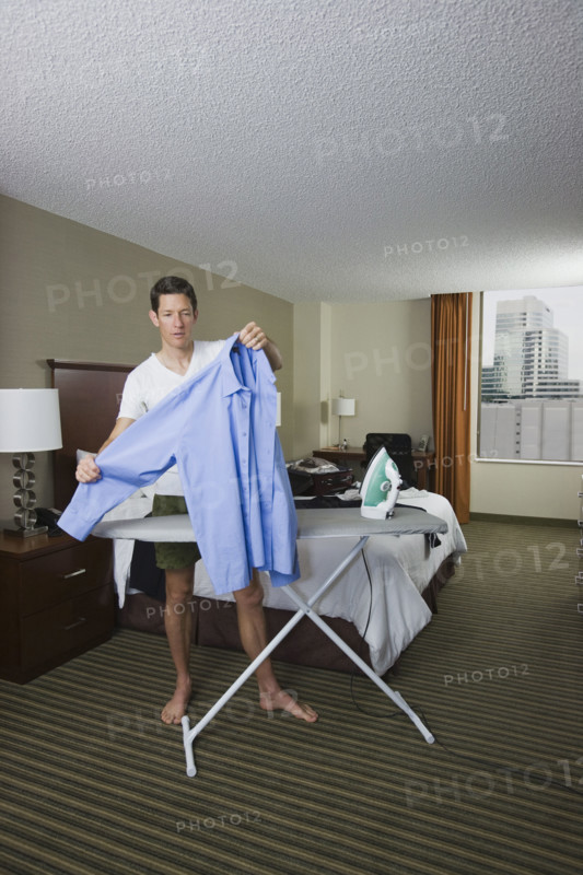 Businessman ironing shirt . Date : 2008