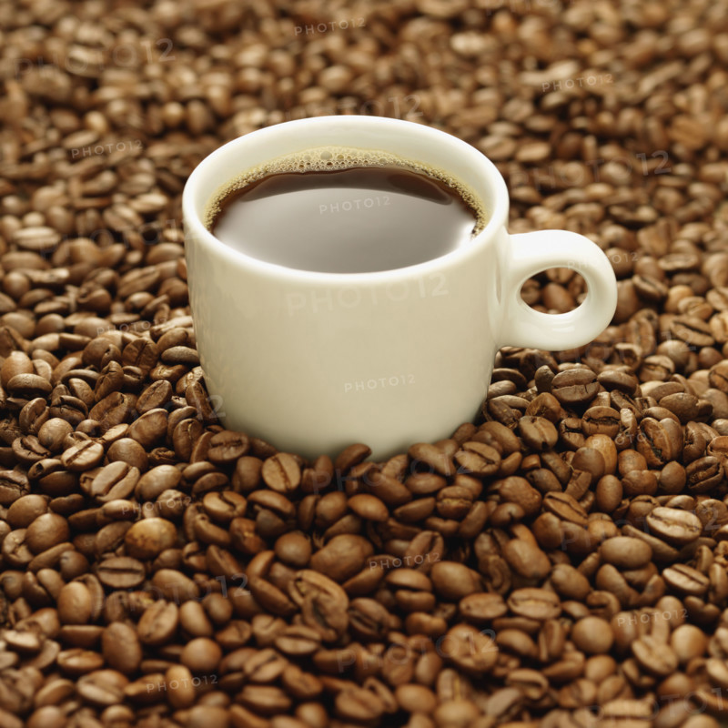 Cup of coffee surrounded by coffee beans. Date : 2008