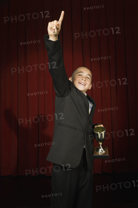 Boy holding trophy on stage. Date : 2008