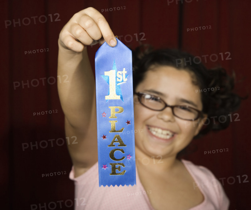 Girl holding first place ribbon on stage. Date : 2008