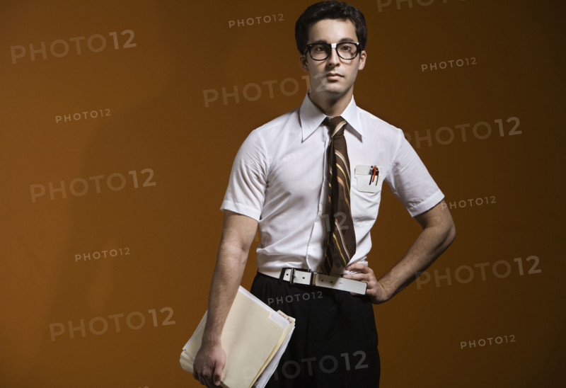 Nerdy man holding school books. Date : 2008