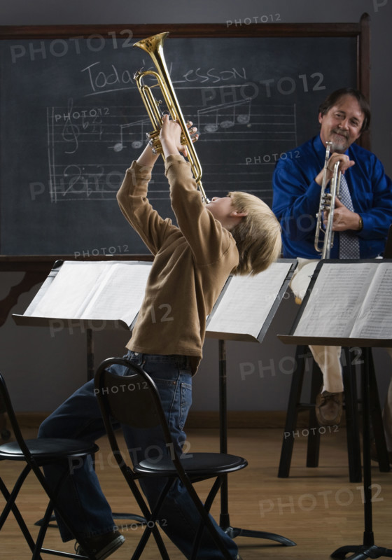 Boy playing trumpet in classroom. Date : 2008