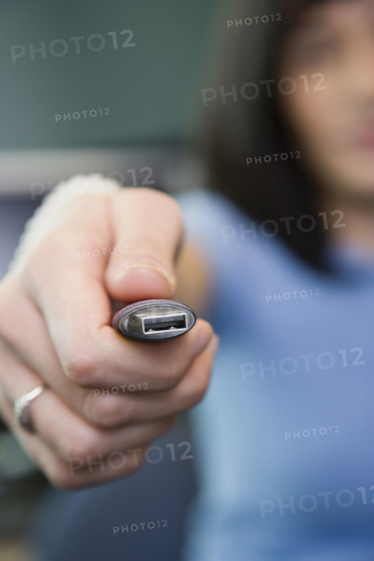 Woman holding USB drive. Date : 2008