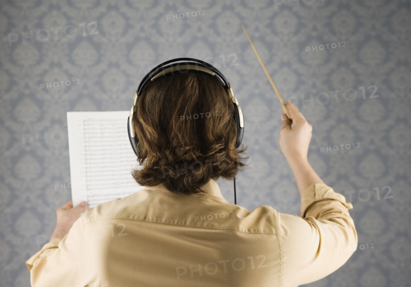 Man listening to headphones and conducting. Date : 2008