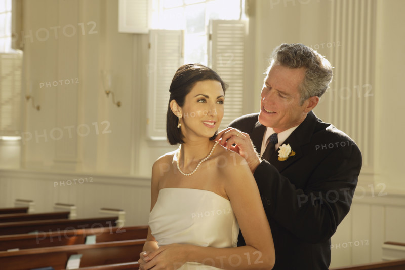 Father fastening bride’s necklace. Date : 2008