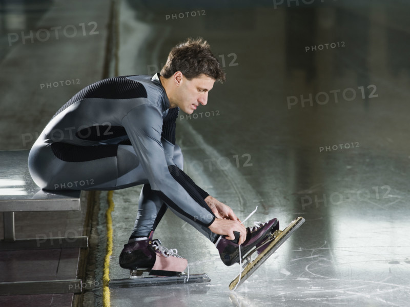 Male speed skater ties skate lace. Date : 2008