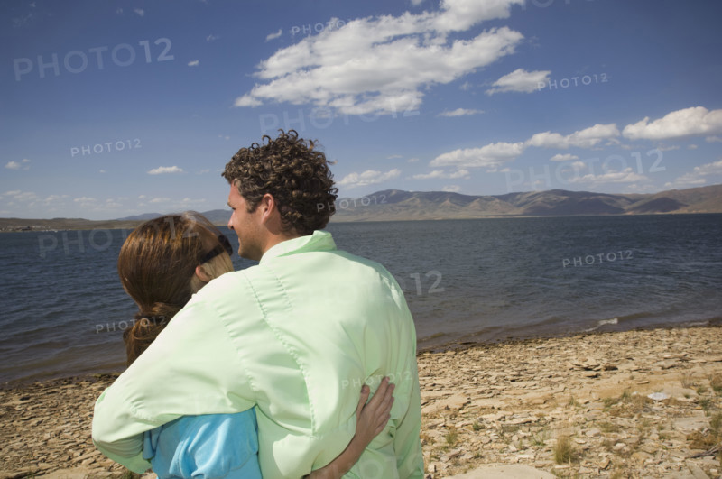 Couple hugging in front of lake, Utah, United States. Date : 2008
