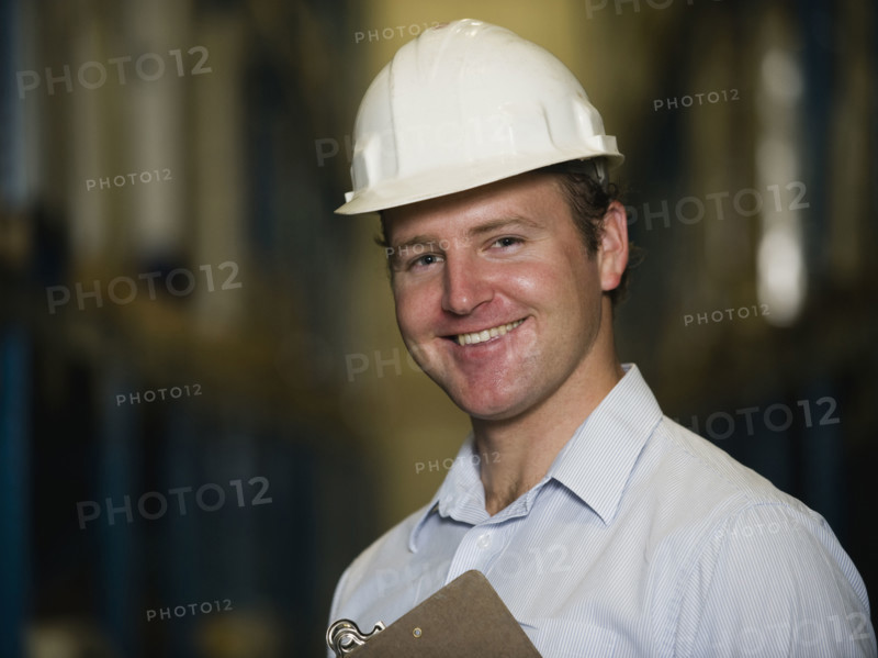 Man wearing hard hat and holding clipboard. Date : 2008