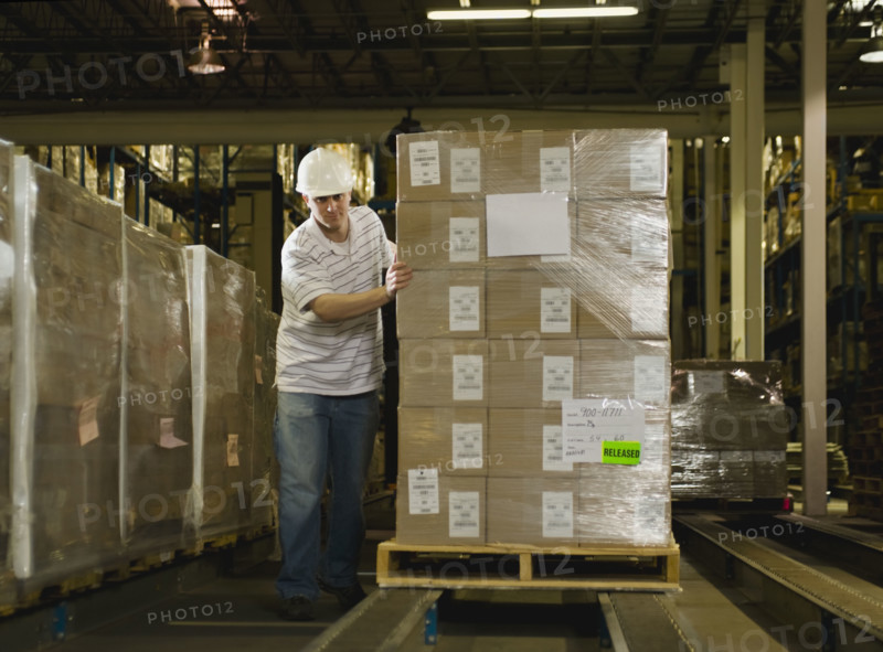 Warehouse worker pushing palette. Date : 2008