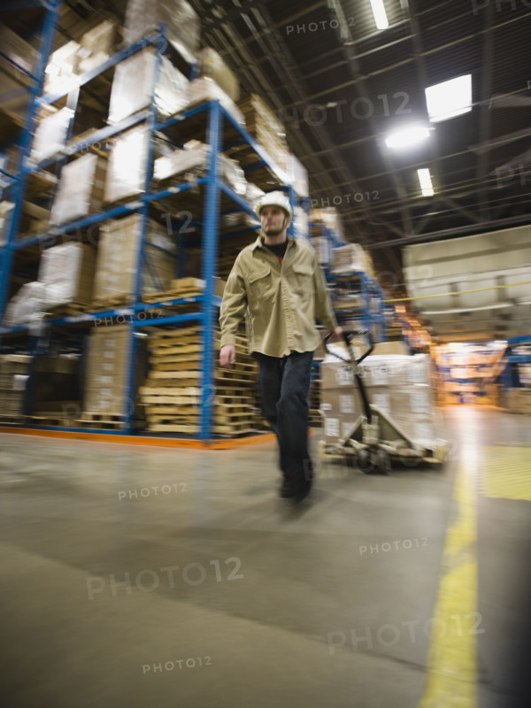 Warehouse worker pulling palette. Date : 2008