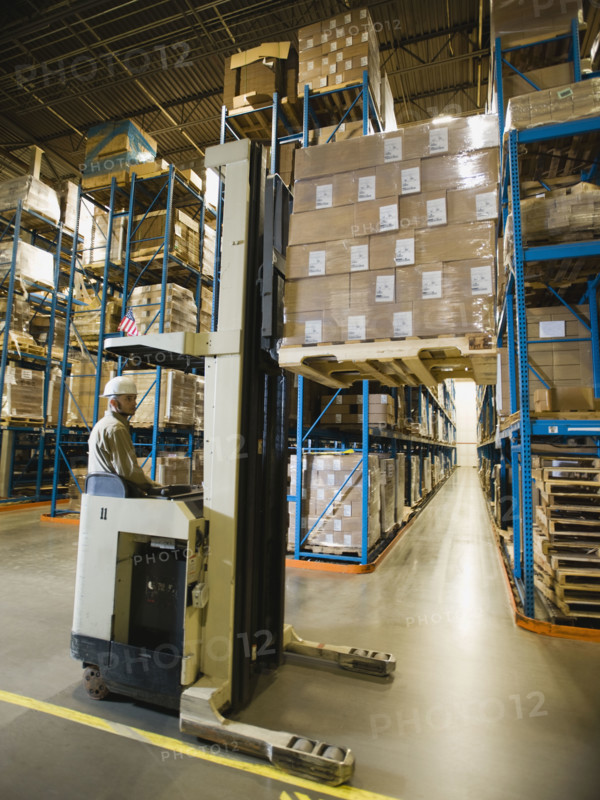 Warehouse worker driving forklift. Date : 2008