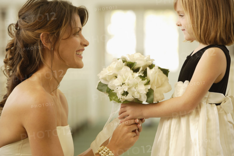 Bride handing bouquet to flower girl. Date : 2008
