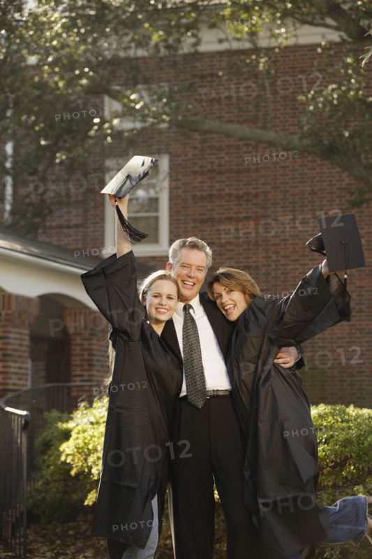 Women graduates with father cheering. Date : 2008