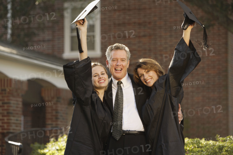 Women graduates with father cheering. Date : 2008