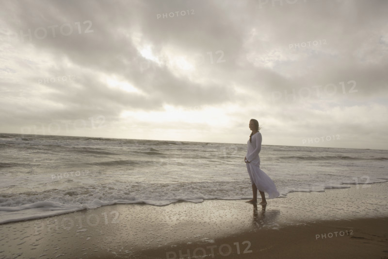 Woman standing in ocean surf. Date : 2008