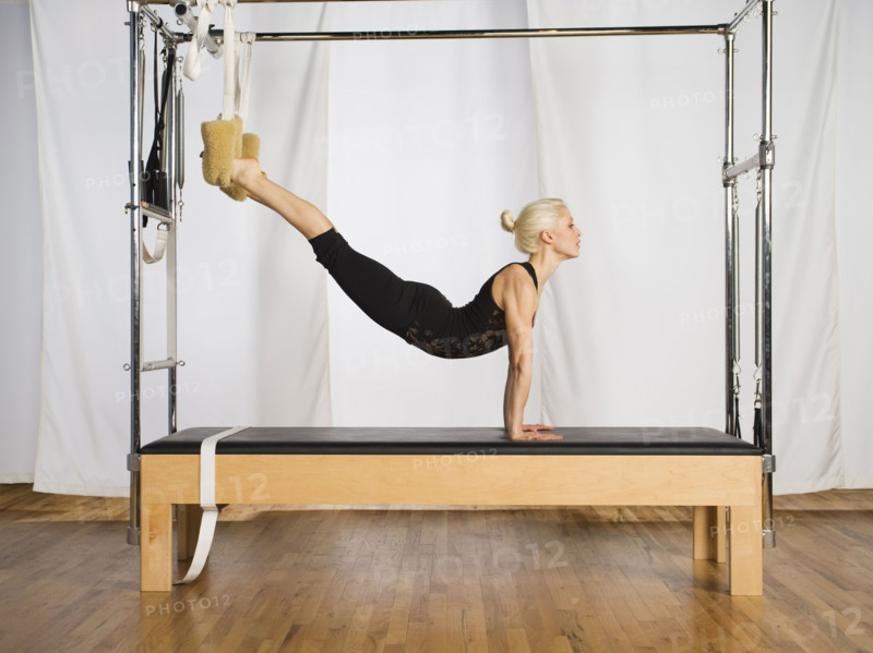 Woman exercising on pilates equipment. Date : 2008