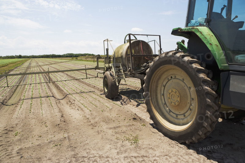 Tractor spraying field, Florida, United States. Date : 2008