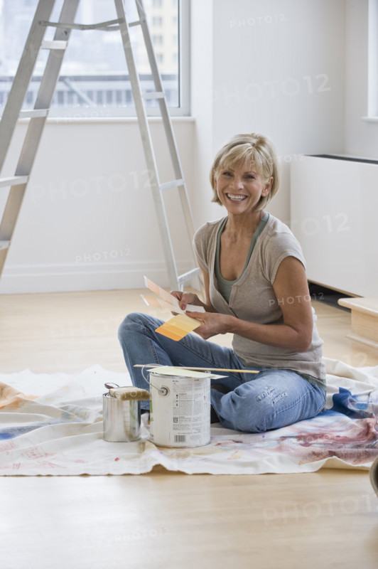 Woman painting room.