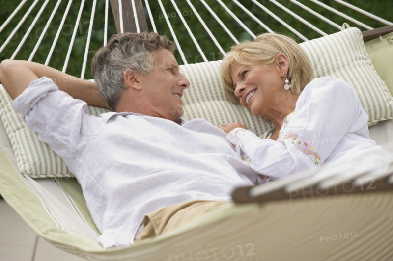 Couple relaxing in hammock.