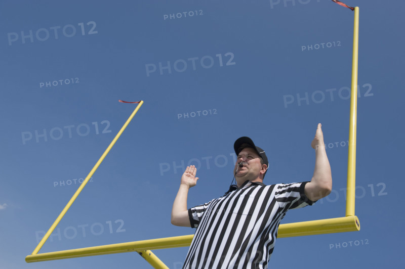 Football referee calling field goal.