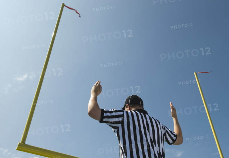 Football referee calling field goal.