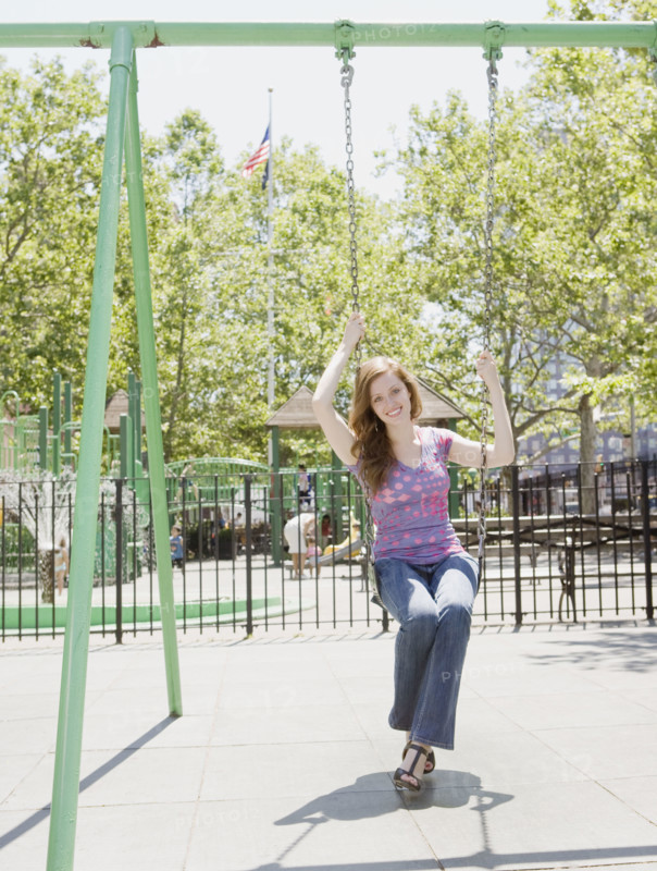 Woman swinging in park. Date : 2008
