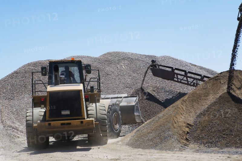 Bucket loader moving pile of gravel. Date : 2008