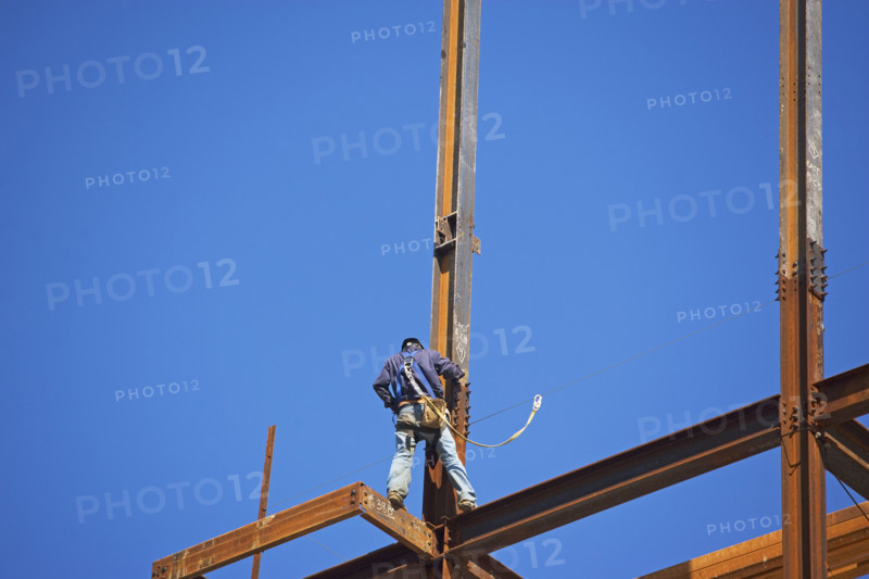 Low angle view of construction worker on beam. Date : 2008