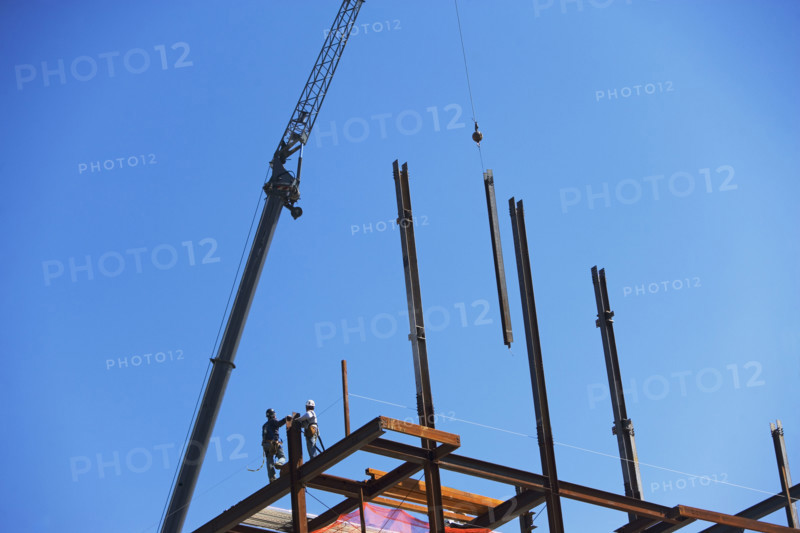 Low angle view of construction workers on beam. Date : 2008