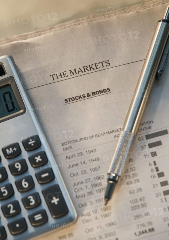 Close up of pen, calculator and financial pages. Date : 2008