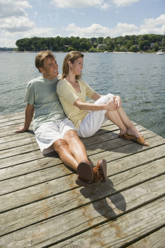 Couple sitting on dock.